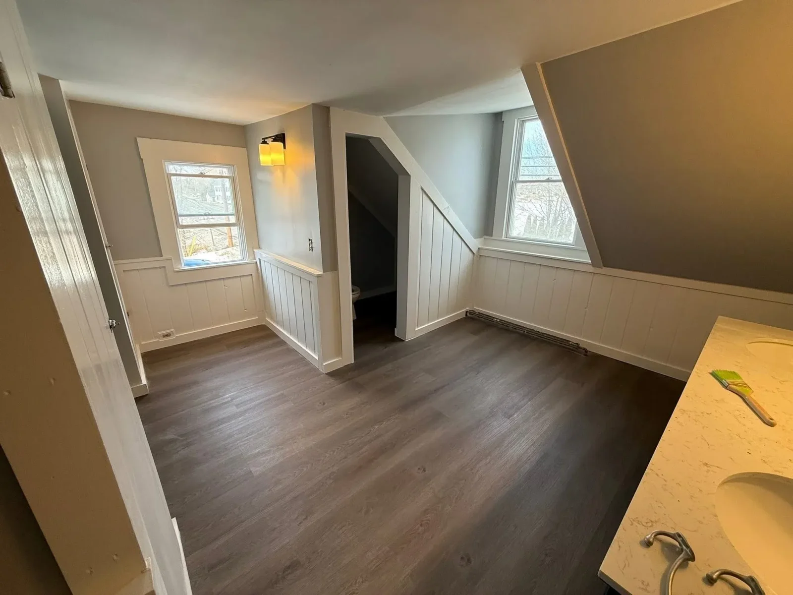 Remodeled interior room with new drywall and tile floor in southern Maine